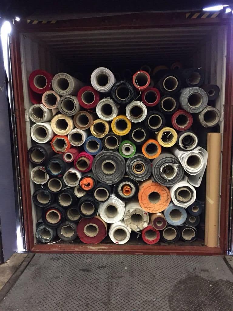 Container packed with mixed material rolls